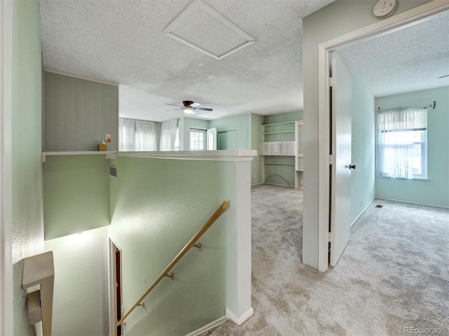 8730 E Roundtree Ave, Greenwood Village, CO 80111 - hallway featuring a textured ceiling, healthy amount of natural light, carpet floors, an upstairs landing, and baseboards
