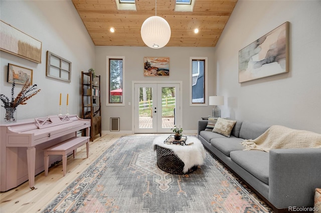 living area featuring french doors, wooden ceiling, a skylight, and light wood-style floors