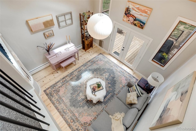 living room featuring french doors, wood finished floors, and baseboards