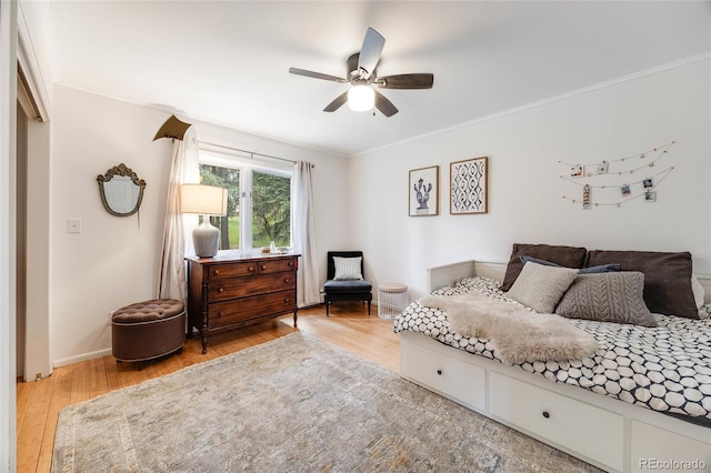 bedroom featuring crown molding, baseboards, and wood finished floors