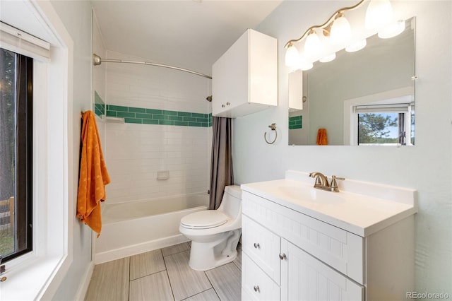 bathroom with shower / tub combo with curtain, vanity, and toilet