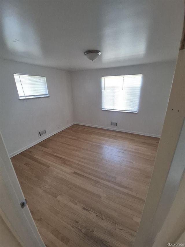 588 Empire St, Aurora, CO 80010 - spare room featuring healthy amount of natural light, wood finished floors, and baseboards