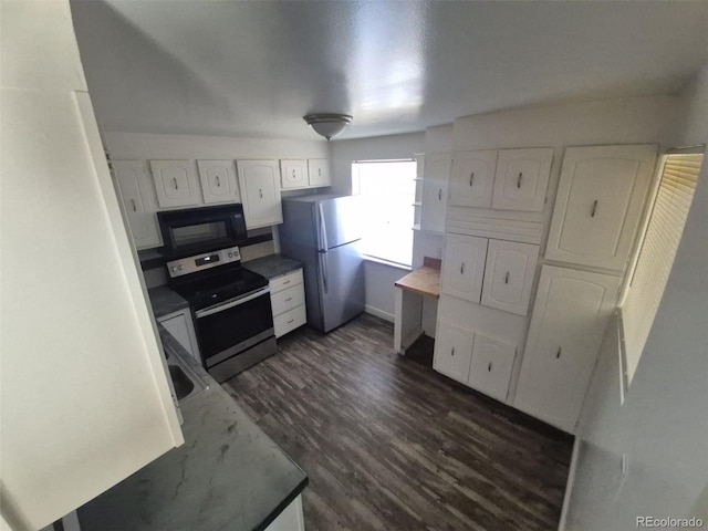 588 Empire St, Aurora, CO 80010 - kitchen featuring black microwave, stainless steel electric range oven, freestanding refrigerator, and white cabinets