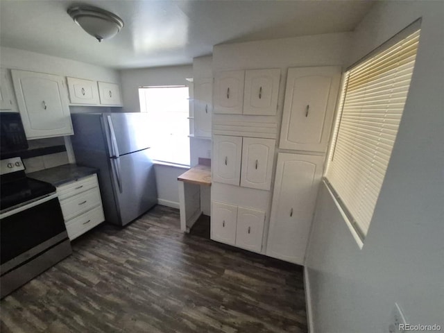 588 Empire St, Aurora, CO 80010 - kitchen featuring appliances with stainless steel finishes, white cabinets, dark wood-style flooring, and baseboards