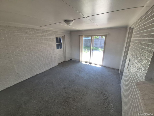 588 Empire St, Aurora, CO 80010 - spare room with brick wall