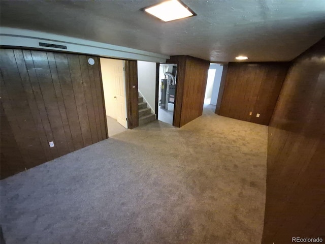 588 Empire St, Aurora, CO 80010 - finished basement with wooden walls, carpet, and stairway