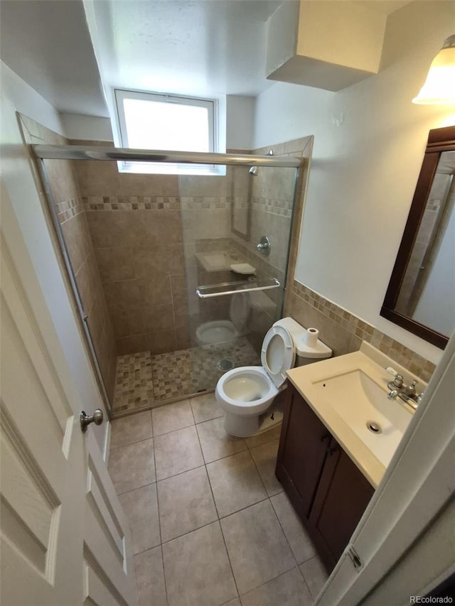 588 Empire St, Aurora, CO 80010 - full bathroom with toilet, vanity, tile patterned floors, a shower stall, and a wainscoted wall