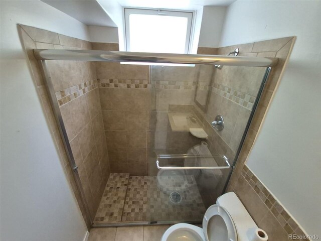 588 Empire St, Aurora, CO 80010 - bathroom featuring toilet, a stall shower, and tile patterned floors