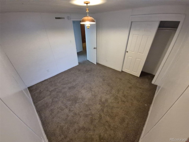 588 Empire St, Aurora, CO 80010 - unfurnished bedroom featuring dark colored carpet and baseboards