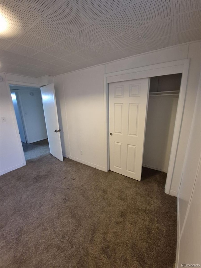 588 Empire St, Aurora, CO 80010 - unfurnished bedroom featuring dark colored carpet and a closet