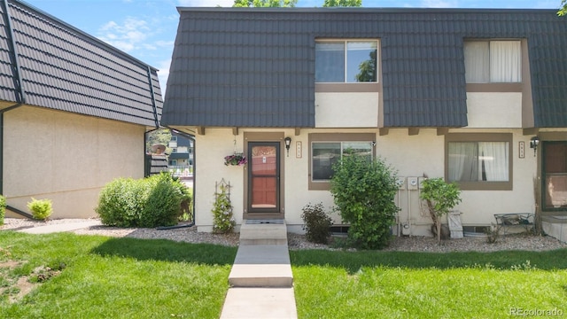 6856 S Broadway, Centennial, CO 80122 - townhome / multi-family property with stucco siding, mansard roof, and a front yard
