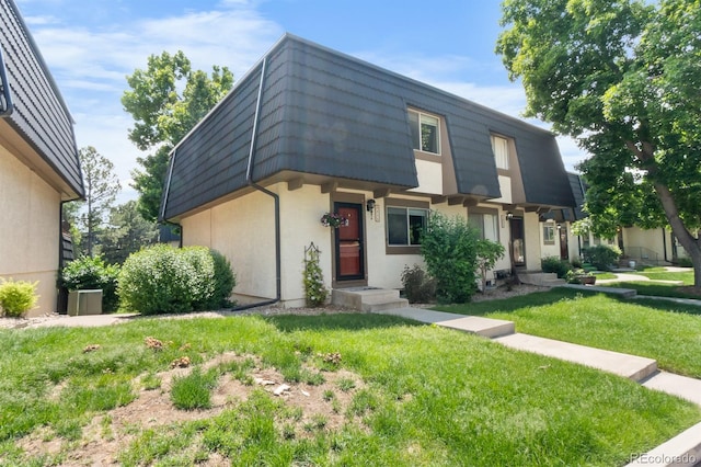 6856 S Broadway, Centennial, CO 80122 - view of front of property with mansard roof, stucco siding, and a front yard