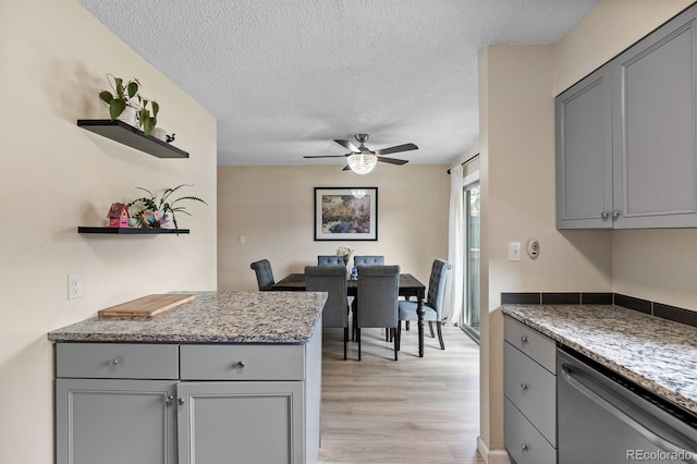 6856 S Broadway, Centennial, CO 80122 - kitchen featuring gray cabinetry, stainless steel dishwasher, light wood-style flooring, ceiling fan, and open shelves