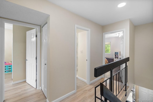 6856 S Broadway, Centennial, CO 80122 - hall featuring light wood-style flooring, an upstairs landing, and baseboards