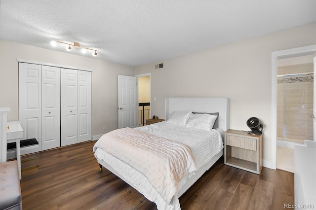 6856 S Broadway, Centennial, CO 80122 - bedroom featuring wood finished floors, a closet, a textured ceiling, and baseboards