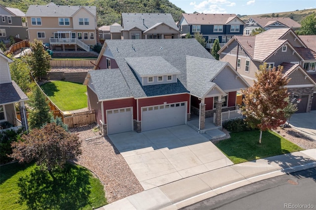 view of front facade with a balcony, a garage, and a front yard