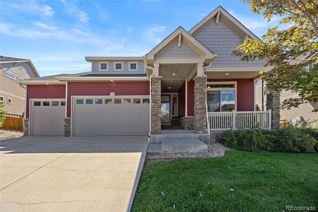 craftsman-style house featuring a front yard and covered porch