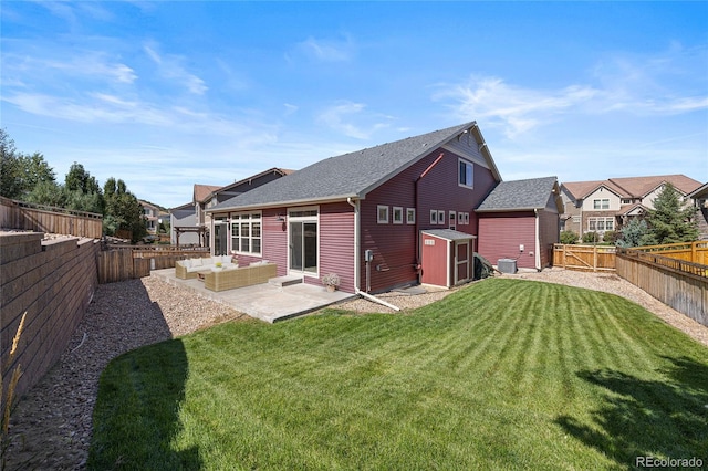 rear view of house featuring a storage unit, a patio area, central air condition unit, and a lawn