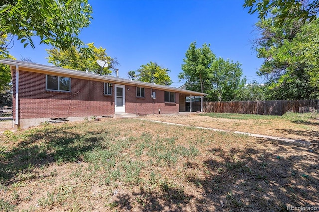 12058 E Virginia Pl, Aurora, CO 80012 - rear view of house featuring brick siding and entry steps