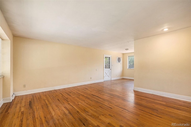12058 E Virginia Pl, Aurora, CO 80012 - empty room with baseboards and wood finished floors