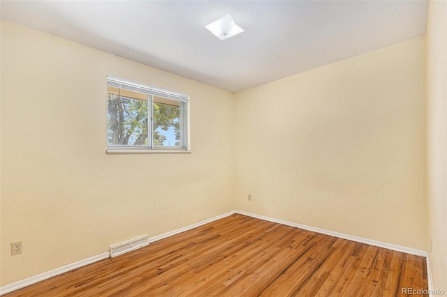 12058 E Virginia Pl, Aurora, CO 80012 - unfurnished room with light wood-style floors and a skylight