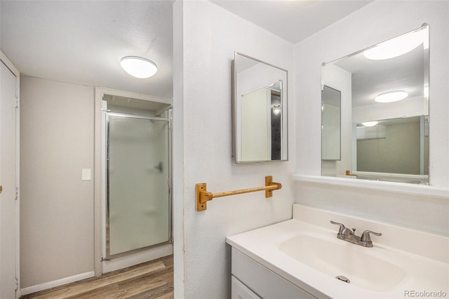12058 E Virginia Pl, Aurora, CO 80012 - bathroom featuring wood finished floors, vanity, and a shower stall