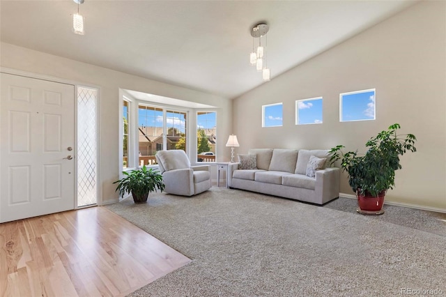 4143 Eagle Ridge Way, Castle Rock, CO 80104 - carpeted living room featuring lofted ceiling and wood finished floors