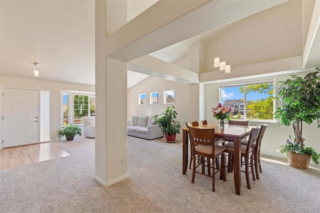 4143 Eagle Ridge Way, Castle Rock, CO 80104 - carpeted dining area featuring a chandelier, plenty of natural light, and high vaulted ceiling