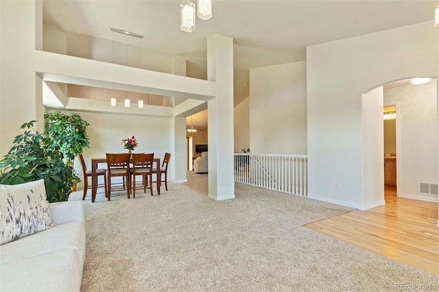 4143 Eagle Ridge Way, Castle Rock, CO 80104 - living room with arched walkways, carpet, and a chandelier
