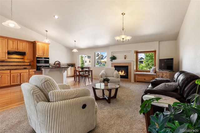 4143 Eagle Ridge Way, Castle Rock, CO 80104 - living room with vaulted ceiling, light carpet, and a tile fireplace
