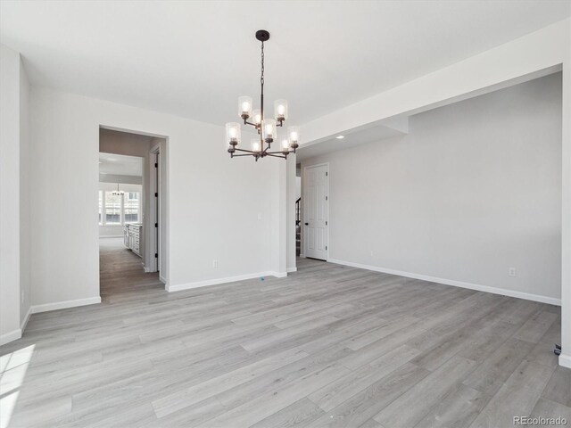 4741 Twelve Oaks Way, Castle Rock, CO 80104 - spare room featuring a chandelier, baseboards, light wood-style floors, and recessed lighting