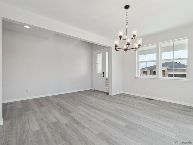 4741 Twelve Oaks Way, Castle Rock, CO 80104 - unfurnished dining area featuring a chandelier, light wood-style floors, and baseboards