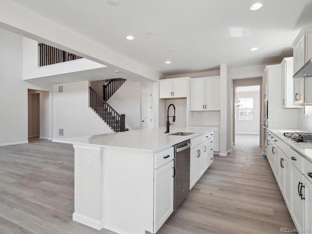 4741 Twelve Oaks Way, Castle Rock, CO 80104 - kitchen featuring appliances with stainless steel finishes, a sink, light wood-type flooring, a center island with sink, and baseboards