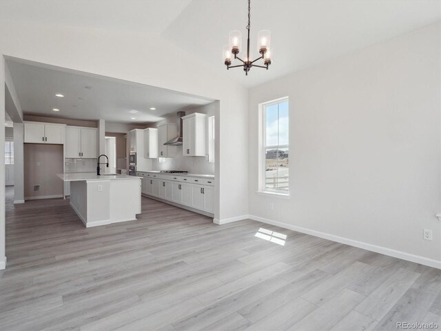 4741 Twelve Oaks Way, Castle Rock, CO 80104 - kitchen with a chandelier, open floor plan, white cabinetry, light countertops, and lofted ceiling