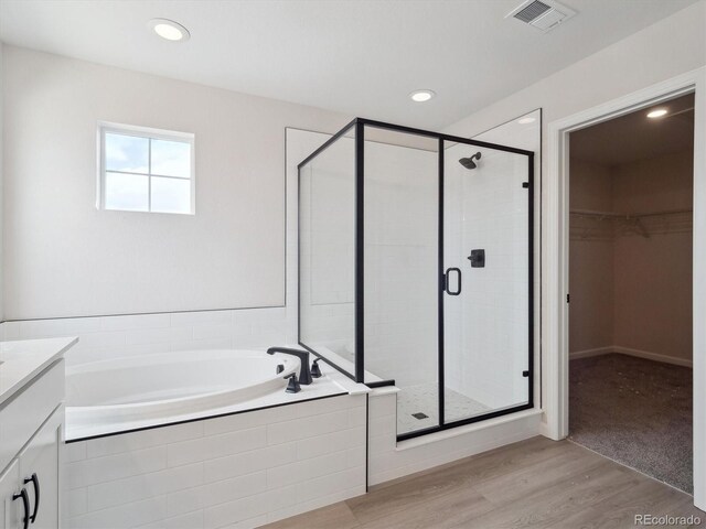 4741 Twelve Oaks Way, Castle Rock, CO 80104 - full bath featuring a bath, a stall shower, vanity, a walk in closet, and wood finished floors