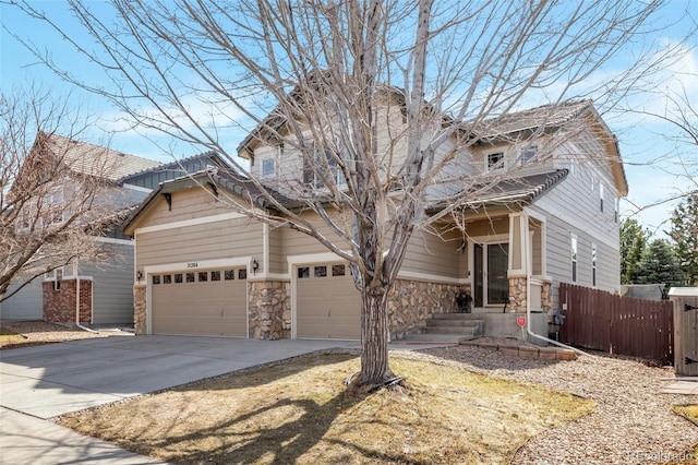 craftsman inspired home featuring stone siding, an attached garage, concrete driveway, and fence