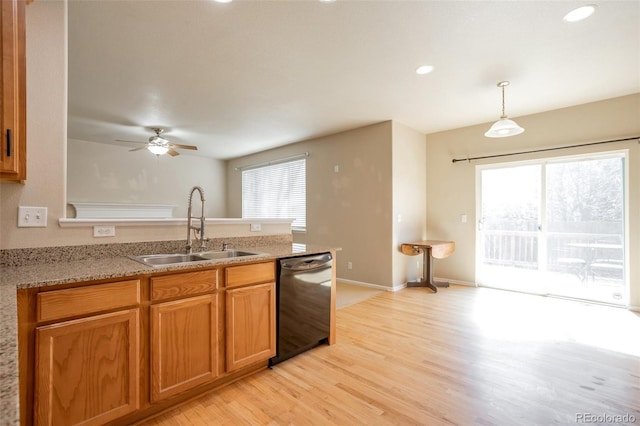 kitchen featuring a wealth of natural light, dishwasher, a peninsula, and a sink