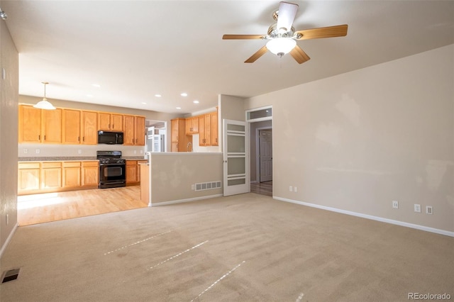 unfurnished living room with baseboards, visible vents, and ceiling fan