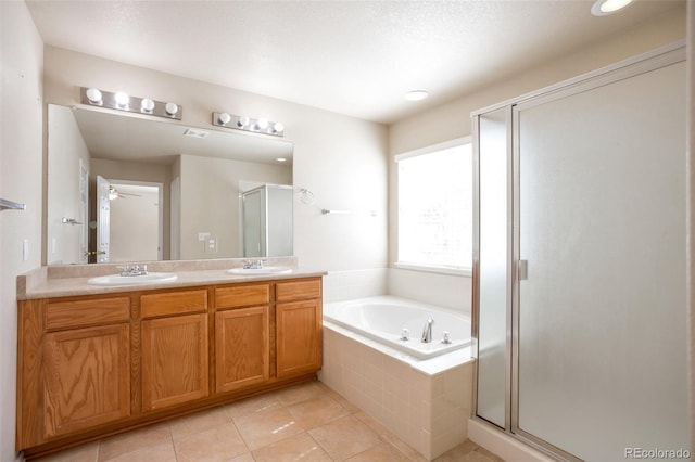 bathroom with a shower stall, tile patterned floors, double vanity, a bath, and a sink