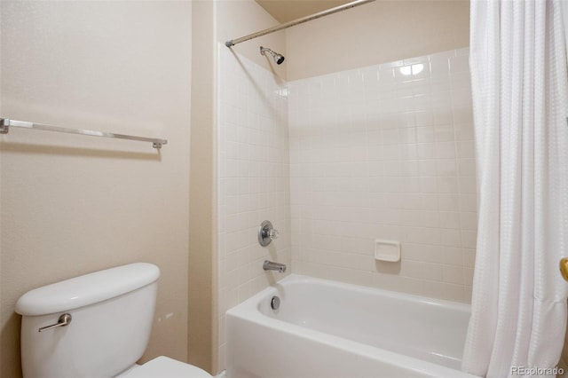 bathroom featuring shower / tub combo and toilet