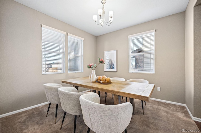 dining space with carpet flooring and a chandelier