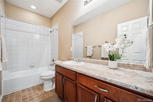 full bathroom with vanity, toilet, and tiled shower / bath combo