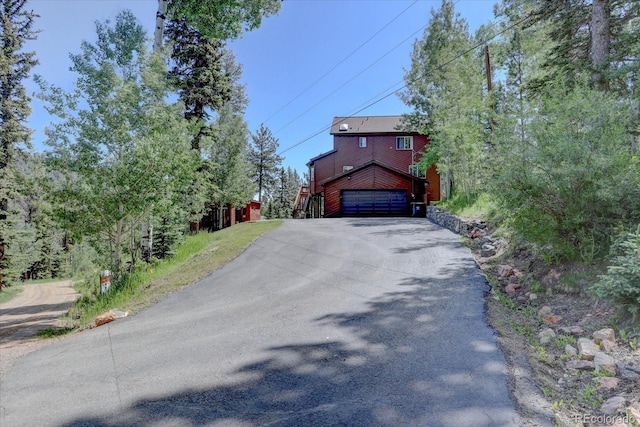 10438 Sunlight Ln, Conifer, CO 80433 - view of front of home featuring driveway and an attached garage