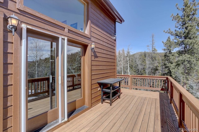 10438 Sunlight Ln, Conifer, CO 80433 - wooden deck featuring a forest view