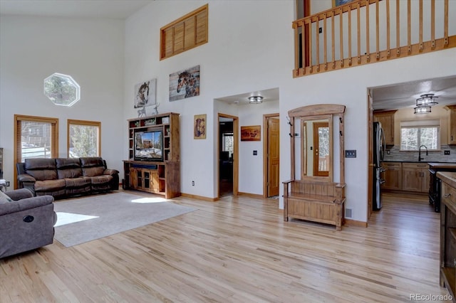 10438 Sunlight Ln, Conifer, CO 80433 - living room with a high ceiling and light wood-type flooring