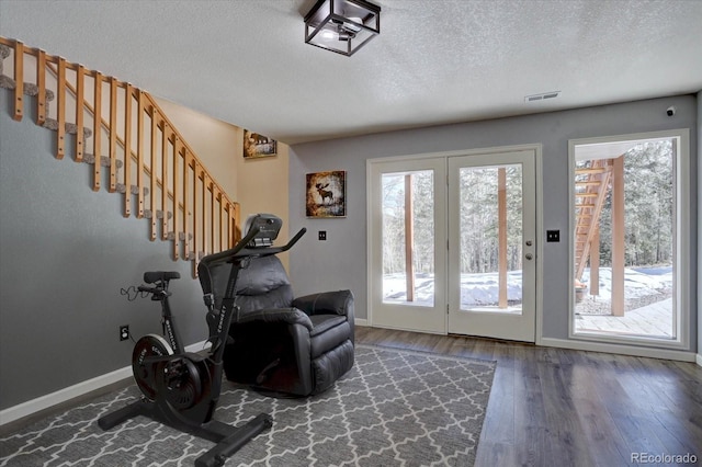 10438 Sunlight Ln, Conifer, CO 80433 - workout area with a textured ceiling and wood finished floors