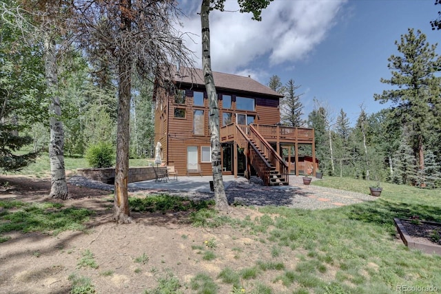 10438 Sunlight Ln, Conifer, CO 80433 - rear view of house with stairway, a deck, and a patio