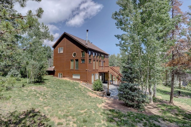 10438 Sunlight Ln, Conifer, CO 80433 - back of house with stairs, a patio, a lawn, a deck, and roof with shingles