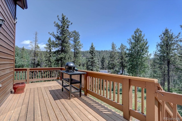 10438 Sunlight Ln, Conifer, CO 80433 - wooden deck featuring a forest view