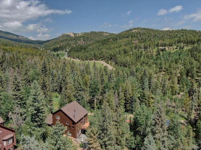 10438 Sunlight Ln, Conifer, CO 80433 - view from above of property with a heavily wooded area and a mountain backdrop